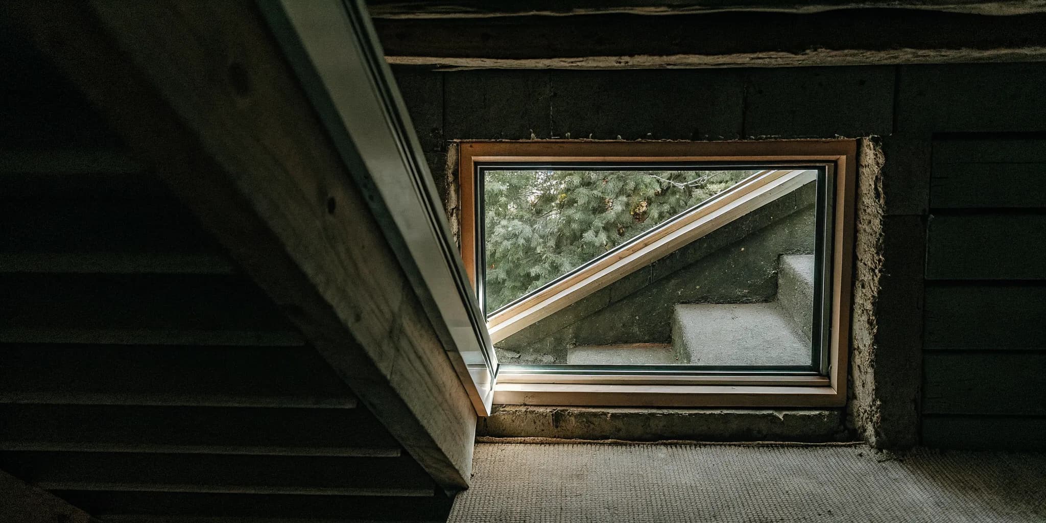 A newly installed basement egress window with warm natural light in South Jersey
