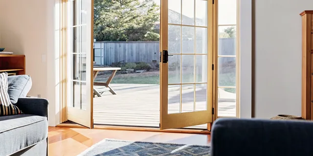 Cosello Construction new sliding glass patio door open to a sunlit South Jersey backyard