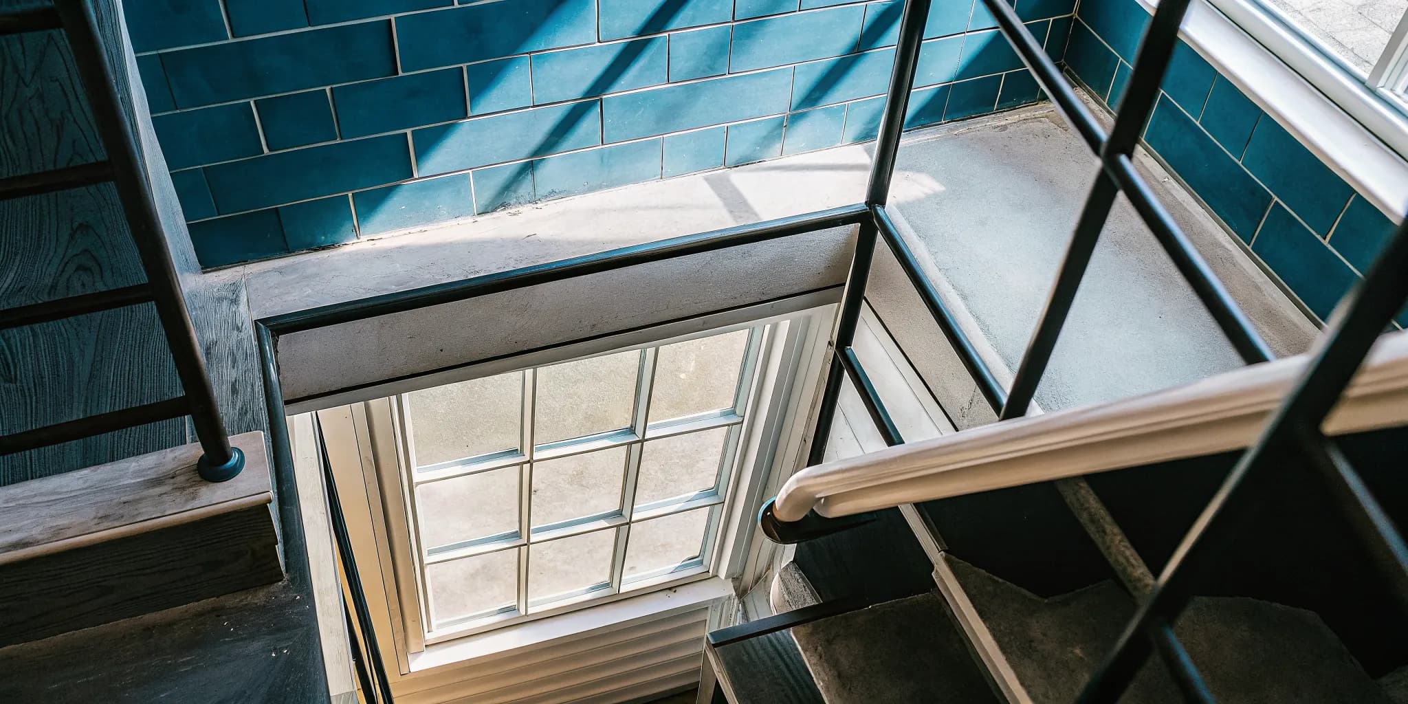 Bright finished basement with a professionally installed egress window and window well letting in natural light
