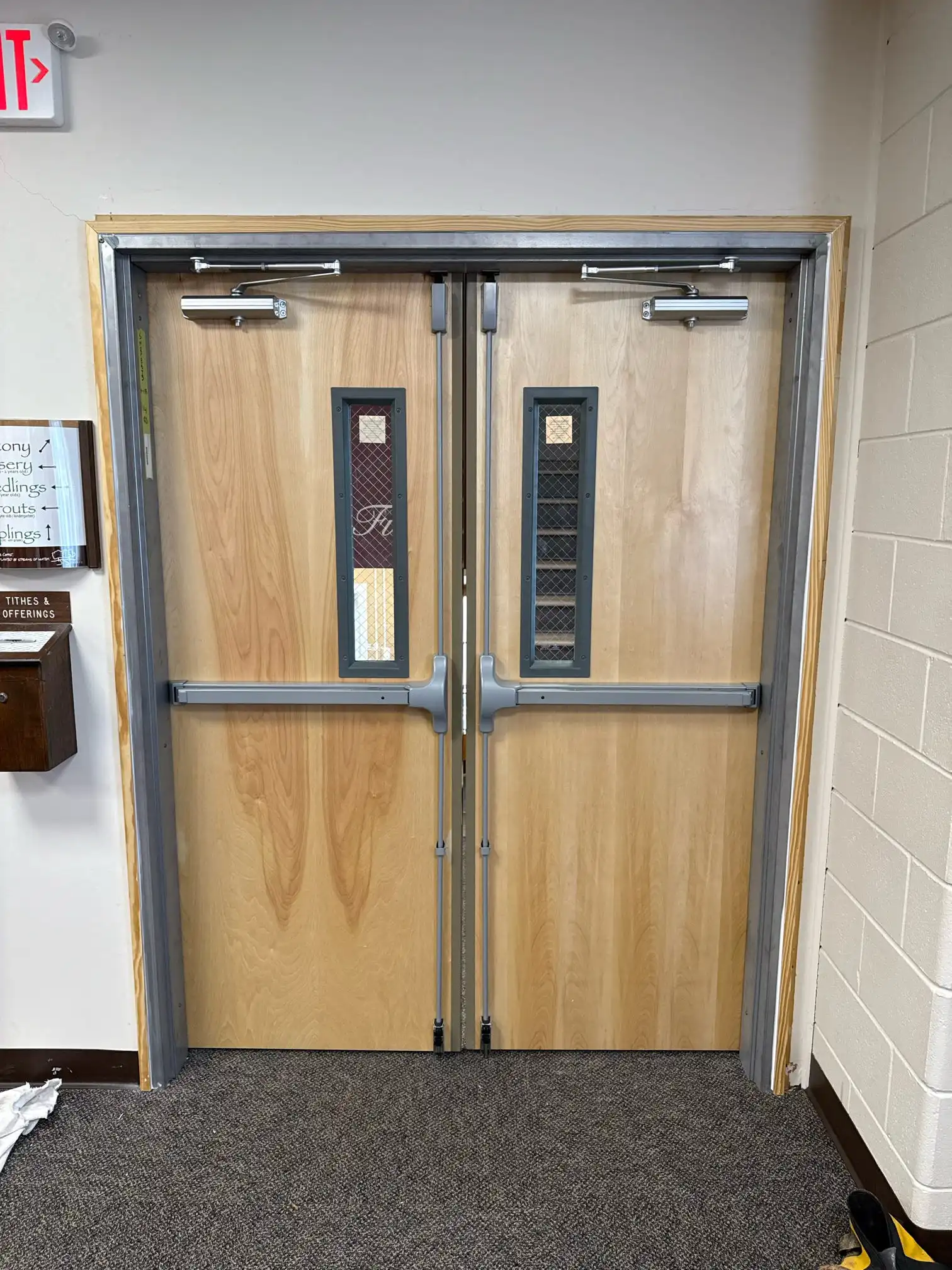 Fire rated exit door installation in a commercial building by Cosello Construction